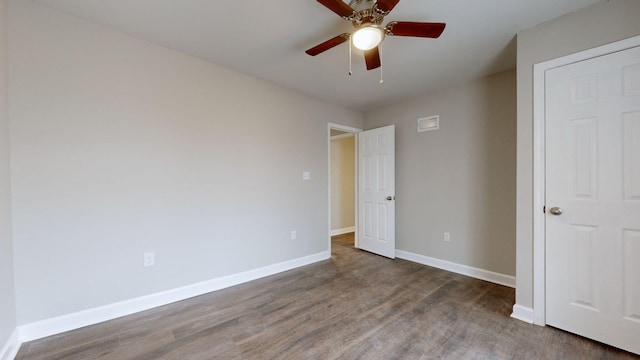 unfurnished bedroom with ceiling fan and dark hardwood / wood-style flooring