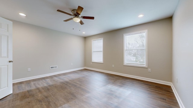 spare room with ceiling fan and dark wood-type flooring