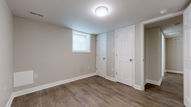 unfurnished bedroom with dark wood-type flooring