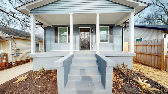 view of exterior entry featuring covered porch