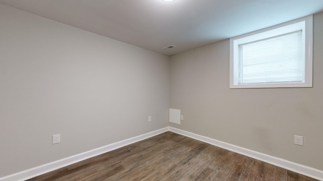 unfurnished room featuring dark hardwood / wood-style flooring