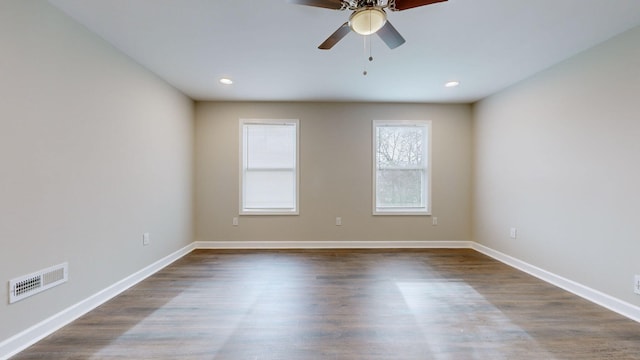 empty room featuring ceiling fan and dark hardwood / wood-style flooring