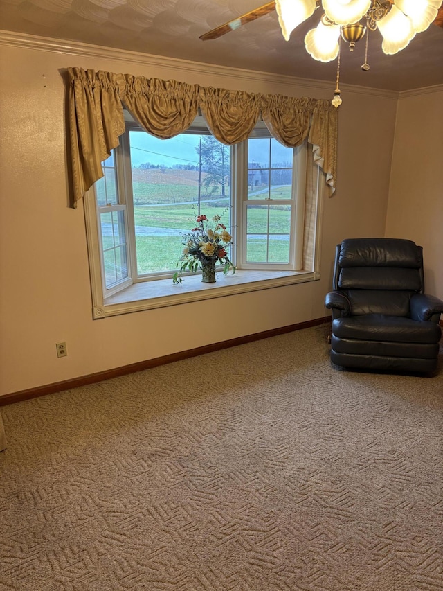 sitting room with carpet flooring, ceiling fan, and crown molding