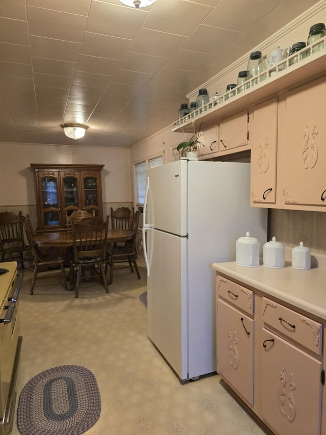 kitchen with white fridge and stainless steel range oven