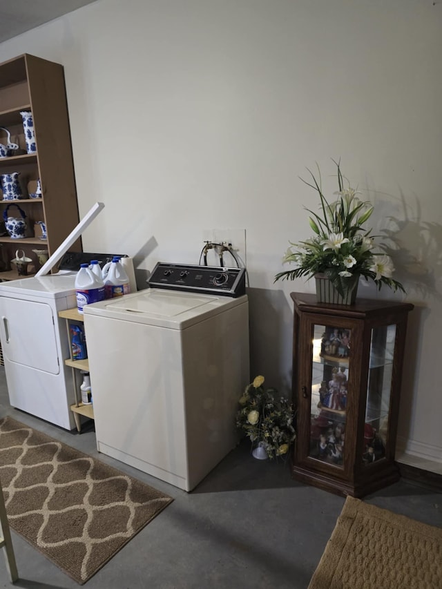 clothes washing area with washer and clothes dryer