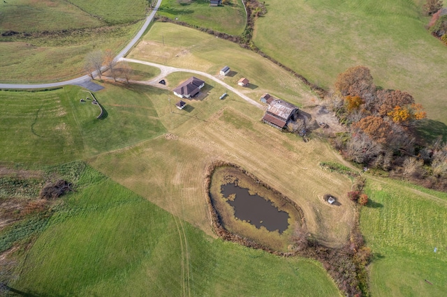 birds eye view of property featuring a water view and a rural view