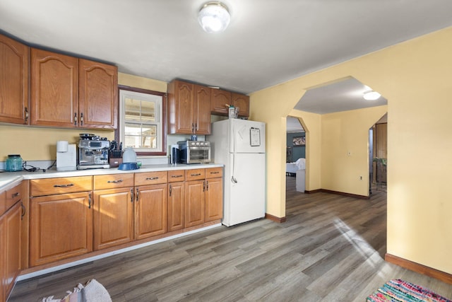 kitchen featuring hardwood / wood-style floors and white refrigerator