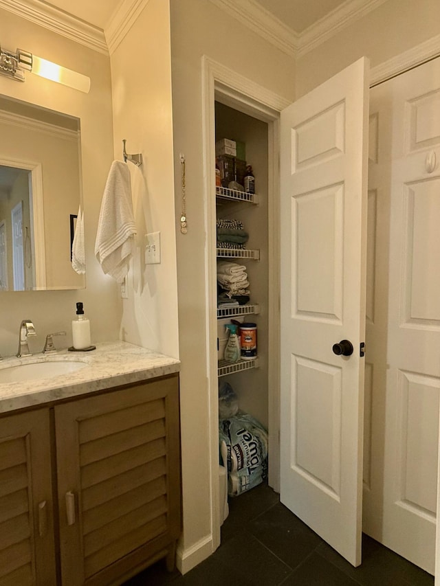 bathroom featuring vanity, tile patterned floors, and ornamental molding