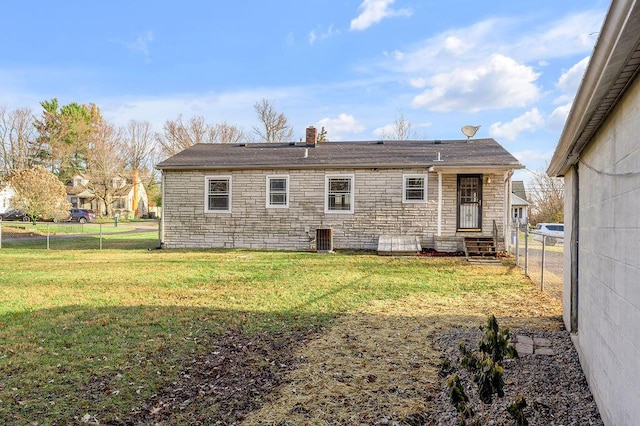 rear view of property with a yard and central AC