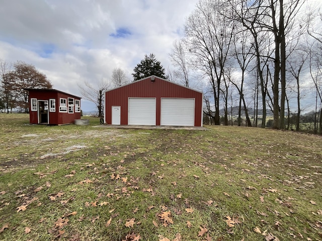 exterior space with an outbuilding and a garage