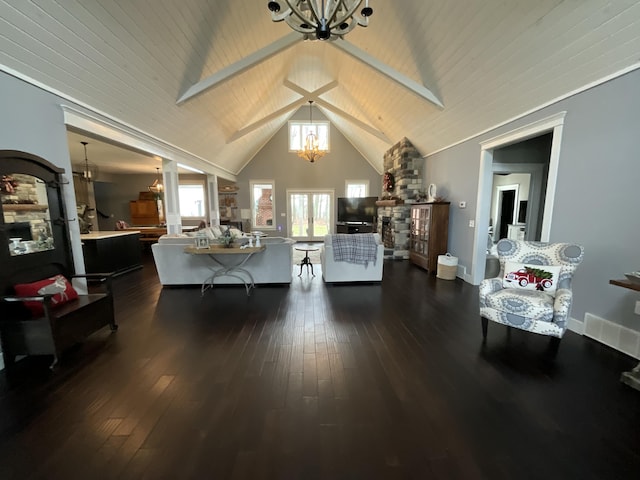 living room with lofted ceiling with beams, dark hardwood / wood-style floors, and an inviting chandelier