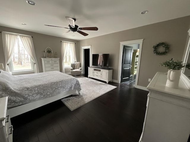 bedroom with ceiling fan and dark wood-type flooring