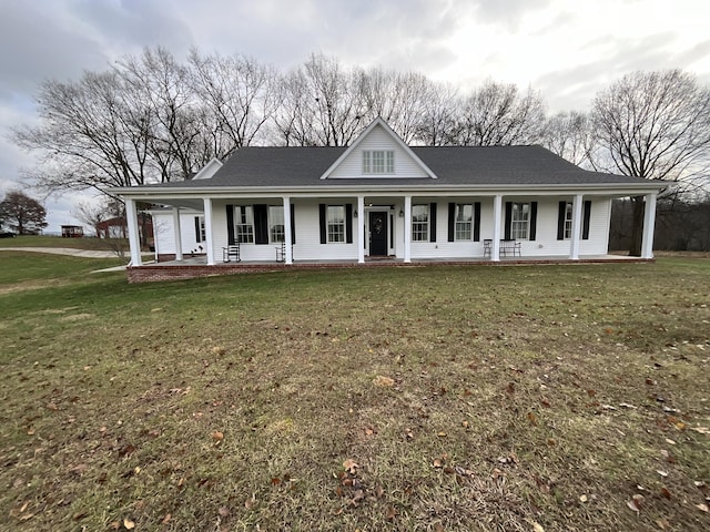 farmhouse-style home featuring a porch and a front yard