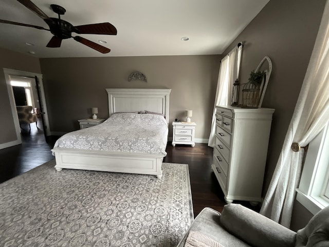 bedroom with dark hardwood / wood-style flooring and ceiling fan