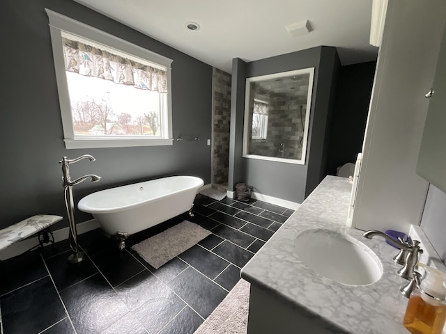 bathroom featuring tile patterned flooring, vanity, and shower with separate bathtub