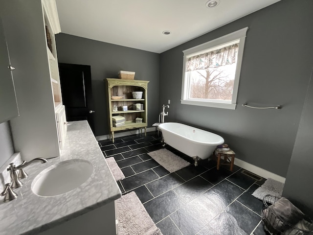 bathroom featuring vanity and a washtub