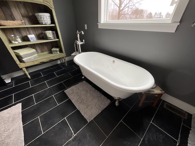 bathroom featuring tile patterned floors and a bathing tub