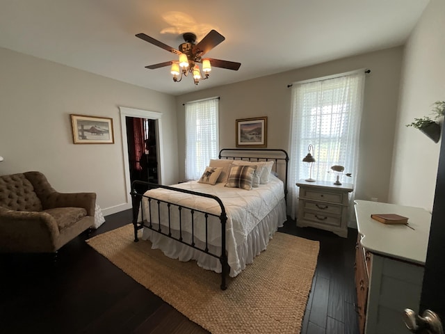 bedroom with ceiling fan and dark hardwood / wood-style flooring