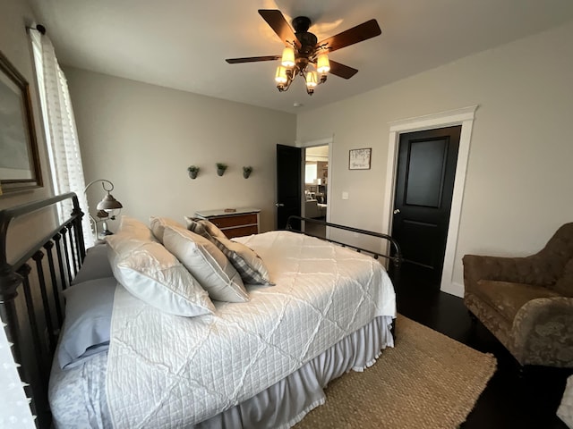 bedroom with dark hardwood / wood-style floors and ceiling fan