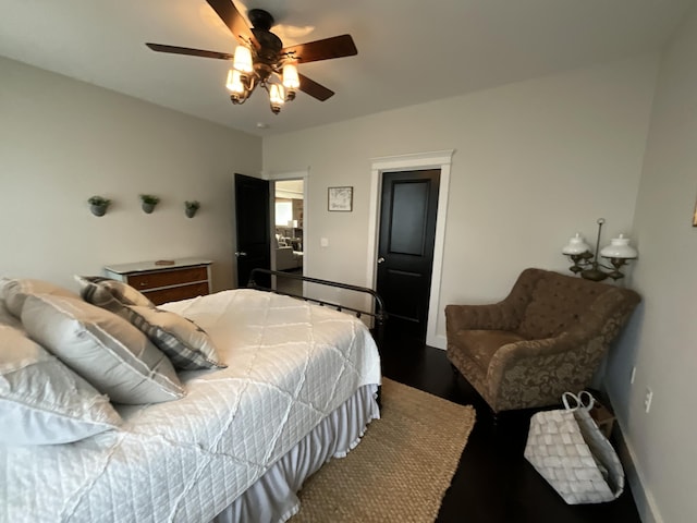 bedroom featuring ceiling fan and dark wood-type flooring