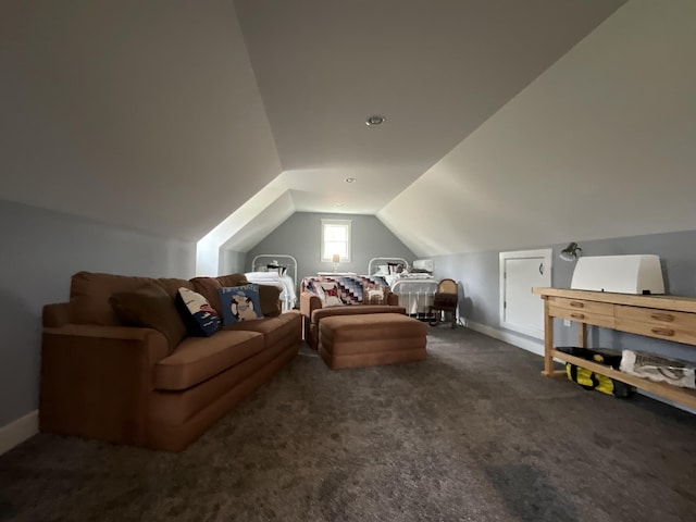 bonus room with dark colored carpet and vaulted ceiling