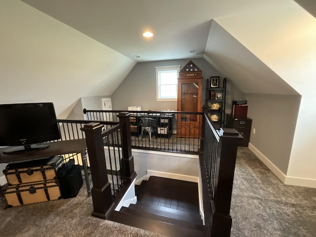 stairs featuring wood-type flooring and lofted ceiling