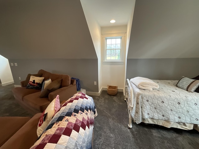 bedroom with dark carpet and vaulted ceiling