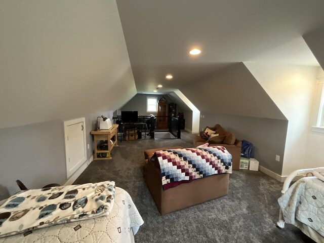 carpeted bedroom with lofted ceiling