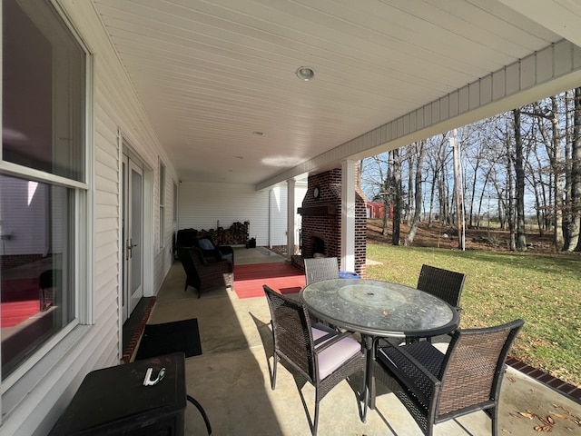 view of patio / terrace featuring an outdoor brick fireplace