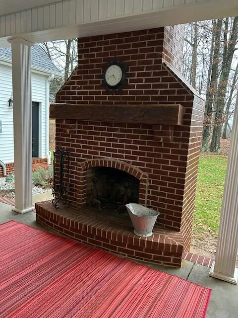 exterior space featuring an outdoor brick fireplace