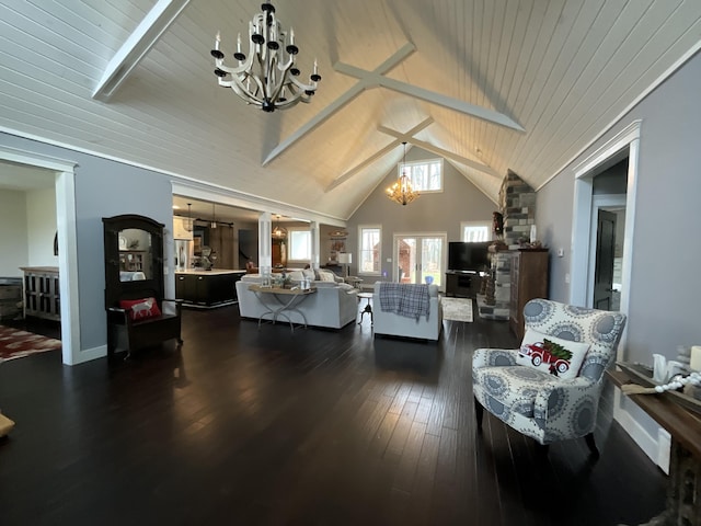 interior space with beamed ceiling, dark wood-type flooring, high vaulted ceiling, and an inviting chandelier