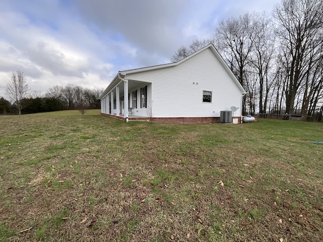 view of home's exterior with a lawn and central air condition unit