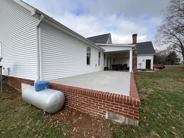 view of home's exterior featuring a yard and a patio