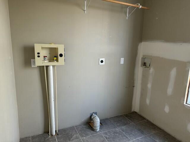 clothes washing area with tile patterned floors, hookup for a washing machine, and hookup for an electric dryer