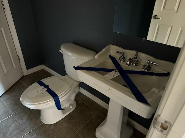 bathroom with tile patterned flooring and toilet