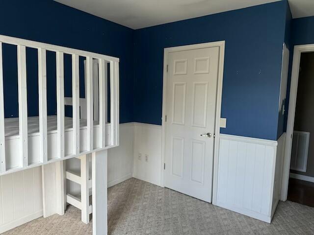 unfurnished bedroom featuring light carpet