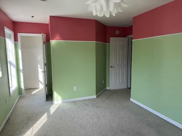 unfurnished bedroom featuring light carpet