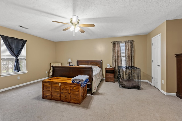 bedroom featuring ceiling fan, light colored carpet, and multiple windows