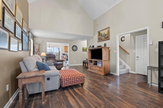 living room featuring dark wood-type flooring and high vaulted ceiling