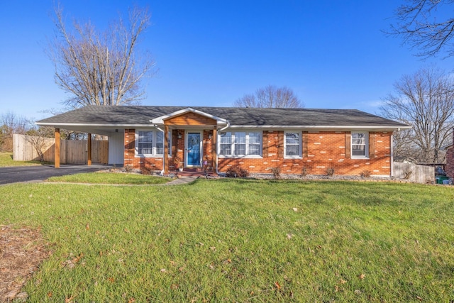 ranch-style home with a front lawn and a carport