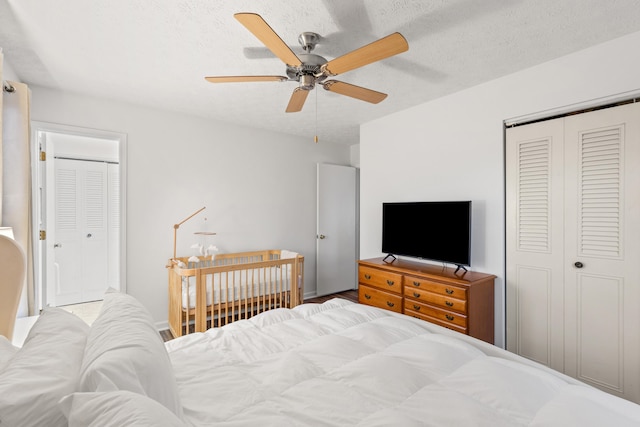 bedroom with a textured ceiling and ceiling fan