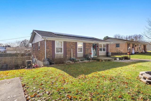 ranch-style house featuring central AC unit and a front yard