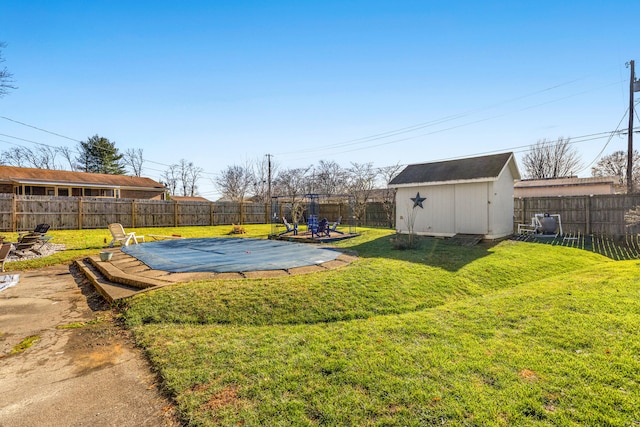 view of yard with a shed and a covered pool