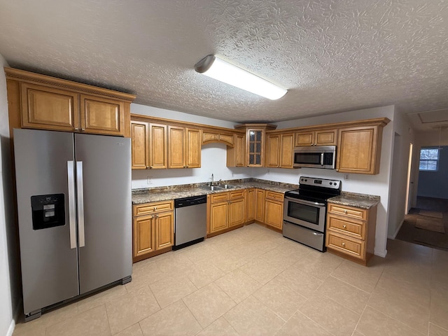 kitchen featuring sink, stainless steel appliances, and a textured ceiling