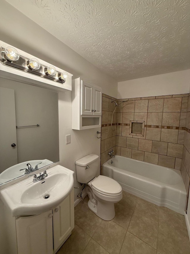 full bathroom with tile patterned floors, vanity, toilet, and a textured ceiling