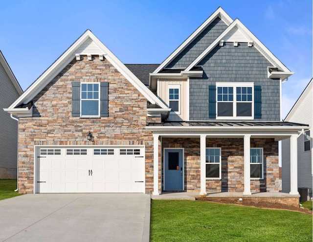 craftsman-style home featuring a standing seam roof, a front lawn, a porch, and concrete driveway