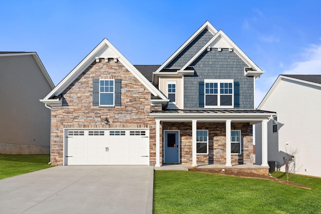 craftsman-style home with a front yard, a standing seam roof, covered porch, and concrete driveway