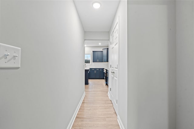 hallway with light hardwood / wood-style floors