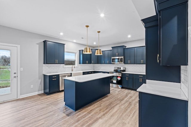 kitchen with pendant lighting, a center island, stainless steel appliances, and blue cabinets