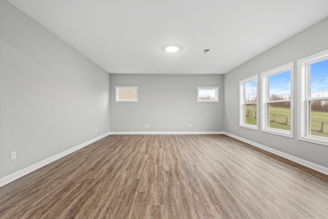 spare room with hardwood / wood-style flooring